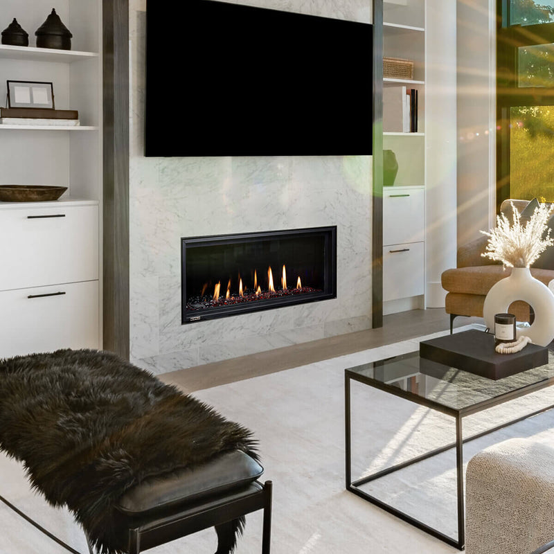 Modern living room with a fireplace, TV, and decorative items.
