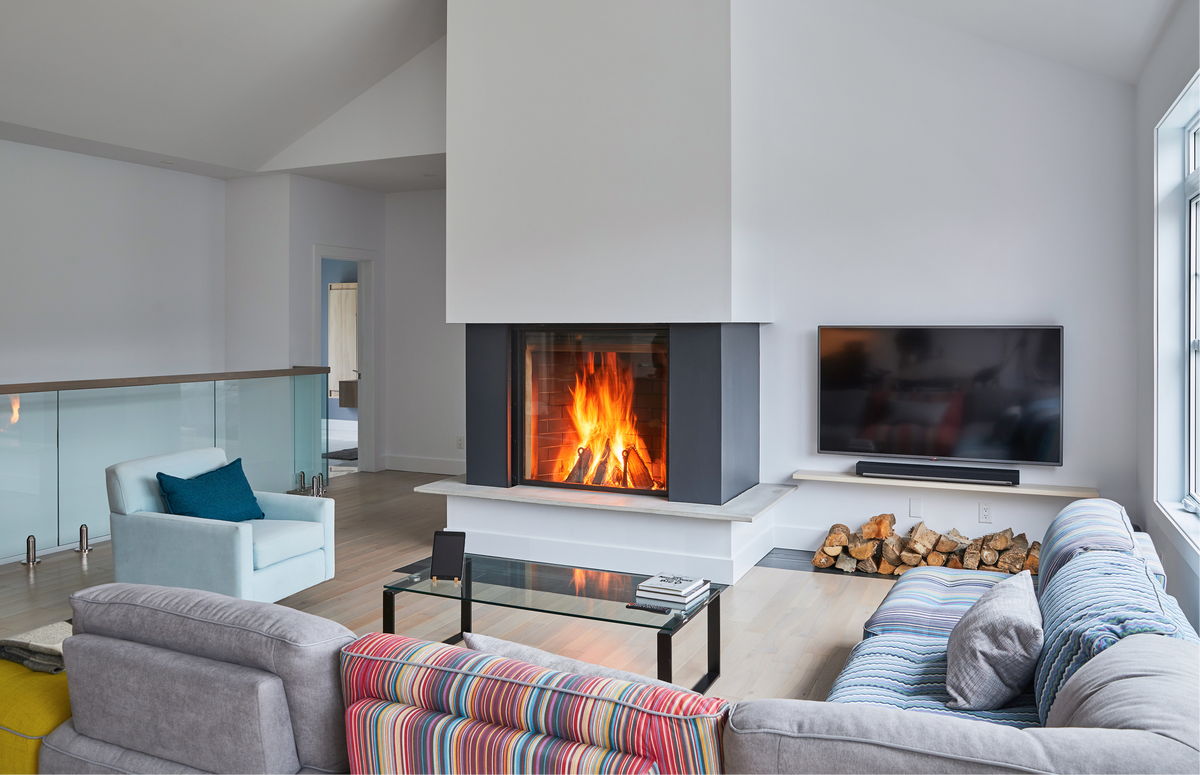 Modern living room with a fireplace, sofa, and TV.