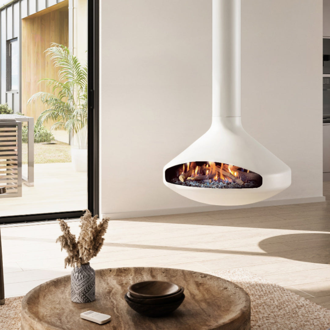 Modern living room with a hanging white fireplace, wooden coffee table, and kitchen in the background.
