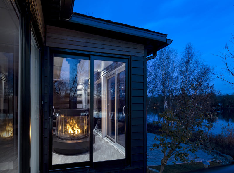 Ortal Stand Alone 360 gas fireplace in a lakeside Magog residence