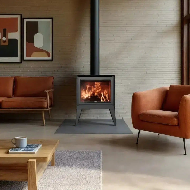 Modern living room with orange sofa, armchair, and wooden coffee table near a fireplace.